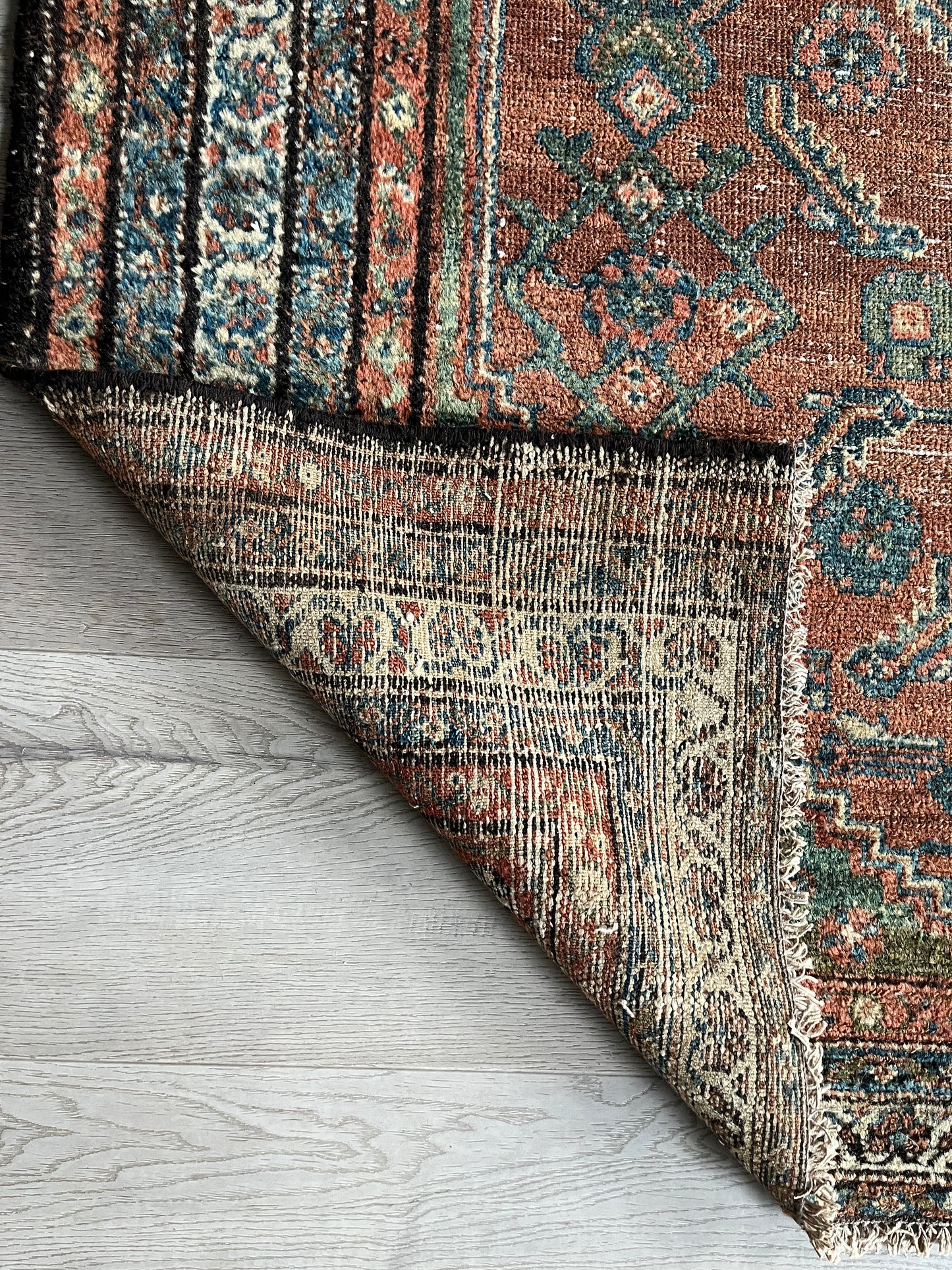 Antique Oriental Rug featuring the rich hues characteristic of renowned Heriz Serapi Rugs