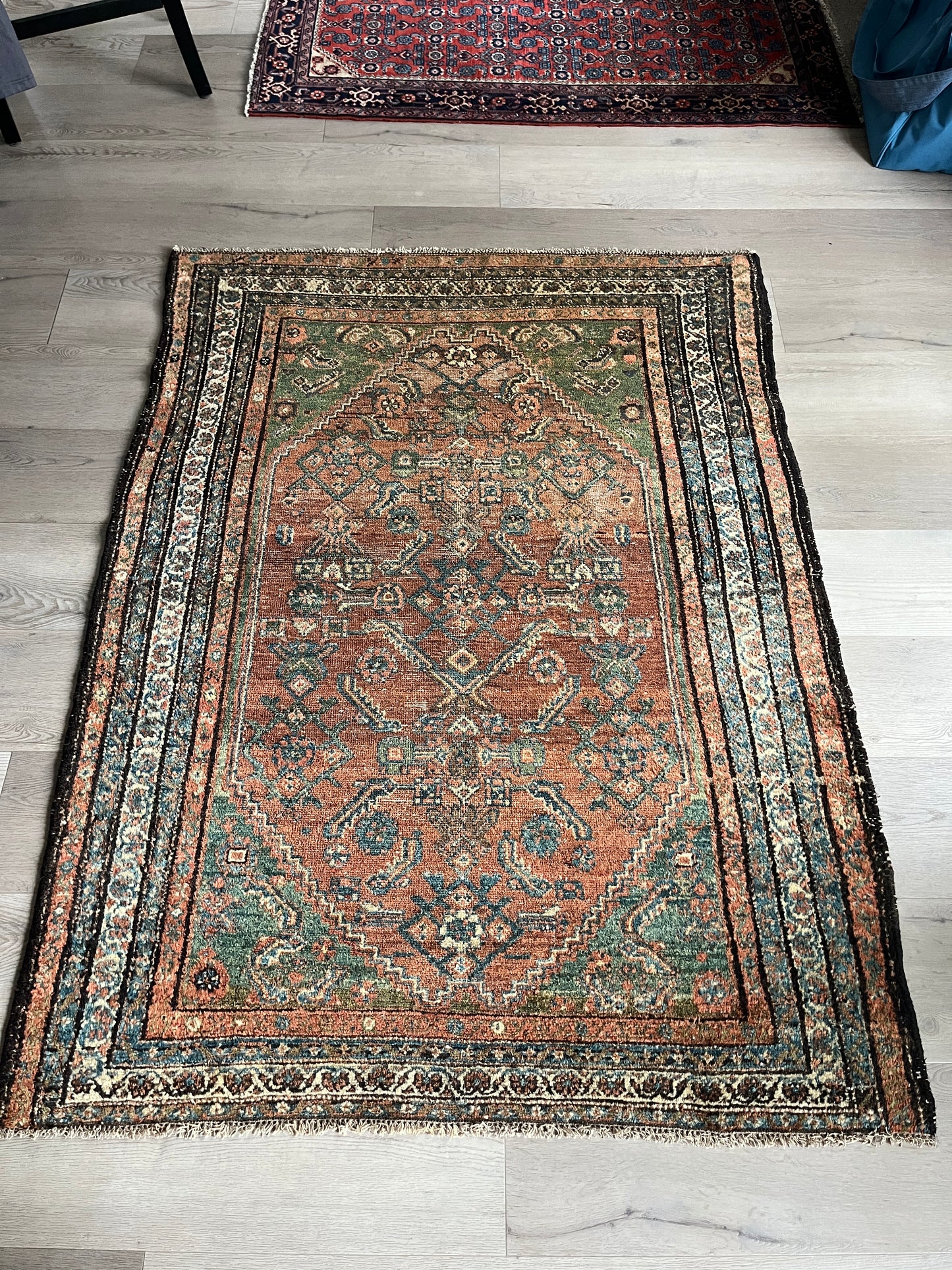 Antique Oriental Rug featuring the rich hues characteristic of renowned Heriz Serapi Rugs