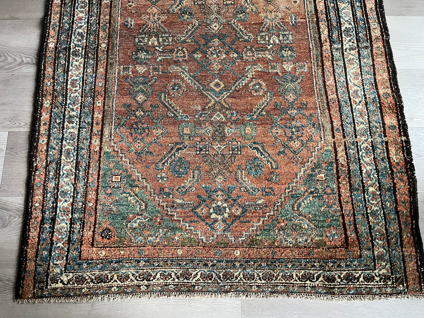 Antique Oriental Rug featuring the rich hues characteristic of renowned Heriz Serapi Rugs