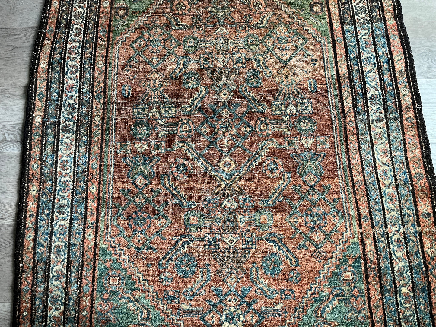 Antique Oriental Rug featuring the rich hues characteristic of renowned Heriz Serapi Rugs