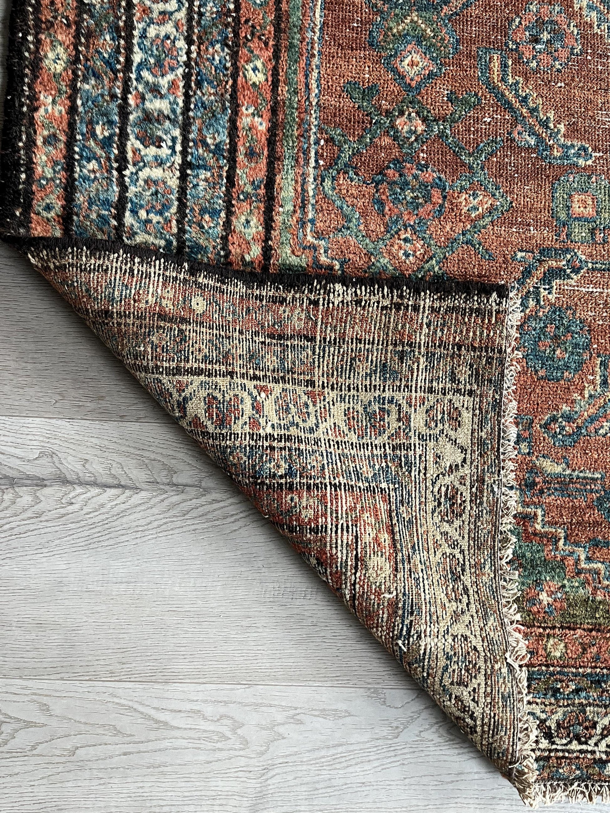 Antique Oriental Rug featuring the rich hues characteristic of renowned Heriz Serapi Rugs