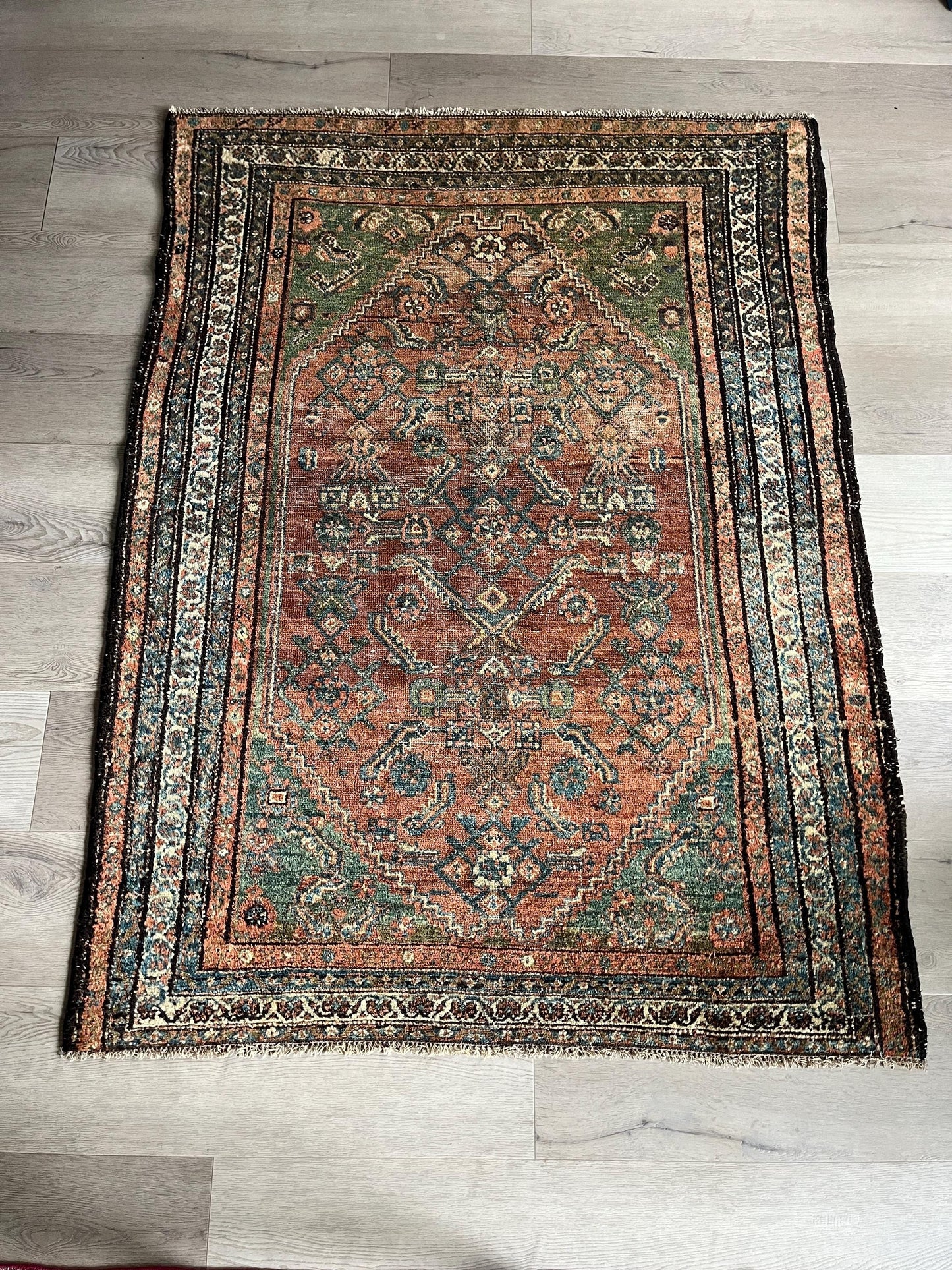Antique Oriental Rug featuring the rich hues characteristic of renowned Heriz Serapi Rugs